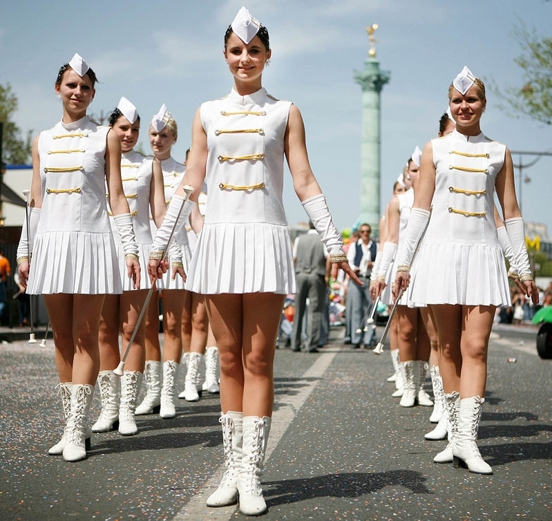 Sexy Majorettes with Bare Legs wearing White Short Dresses and White Boots